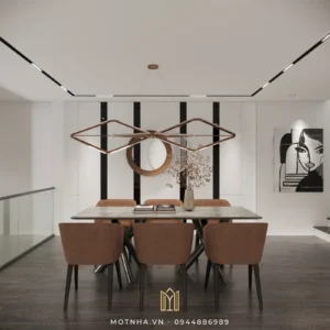 Đèn thả kim loại và mảng gương decor giúp không gian ăn uống sinh động và có chiều sâu.
