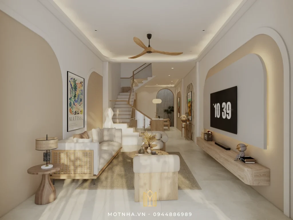 Phòng khách với sofa màu kem, bàn trà gỗ tự nhiên, điểm nhấn là mảng tường vòm bo cong nhẹ kết hợp ánh sáng hắt dịu mắt.